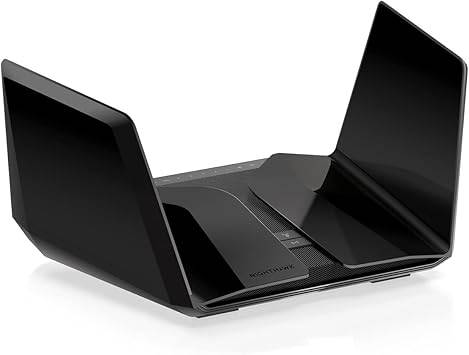 NETGEAR RAXE500-100NAS AXE11000 WiFi 6E tri-band router with antennas and LED indicators on a white background.
