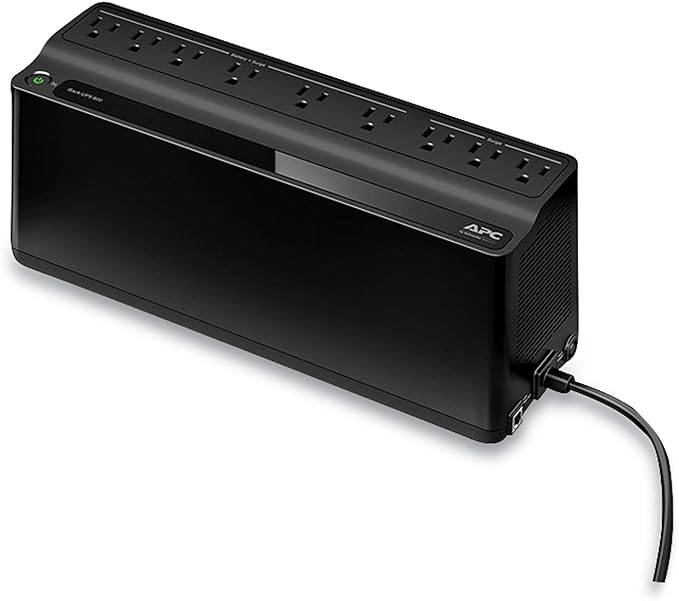Back-up battery for BN900M UPS system, showing a compact black battery unit with connector terminals.