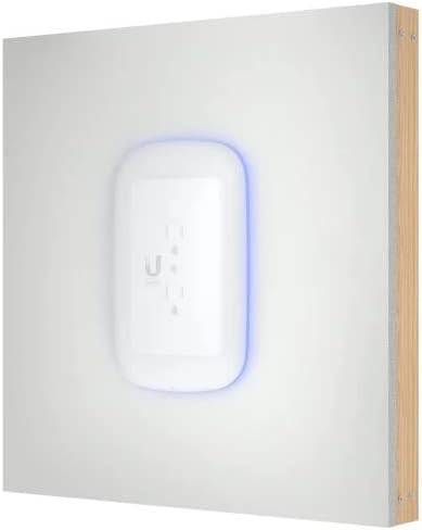 Ubiquiti Unifi 6 dual-band WiFi 6 mesh extender plugged into wall outlet, white wireless networking device.